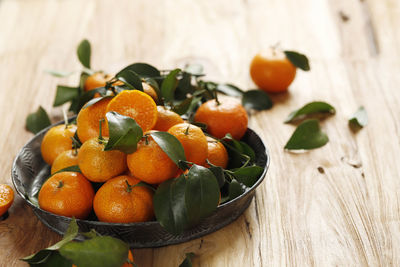 Mandarin orange for imlek chinese new year, served on wooden table. copy space for text