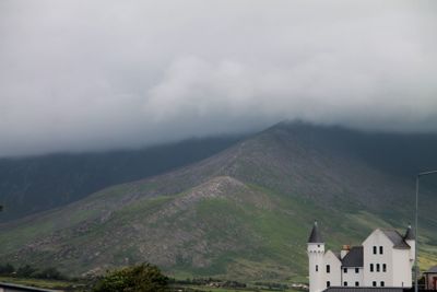 Scenic view of mountains against cloudy sky