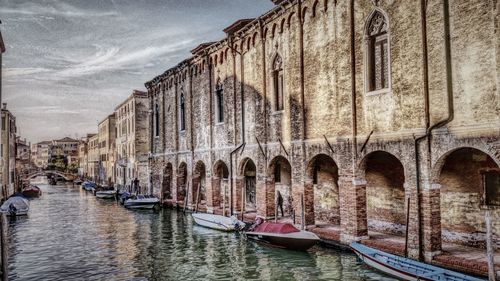 Boats in canal with buildings in background