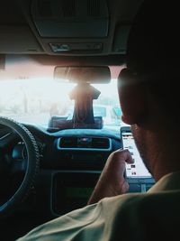 Rear view of woman sitting in car