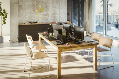 Computers and laptops on desk in creative office