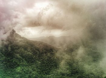 Scenic view of landscape against cloudy sky