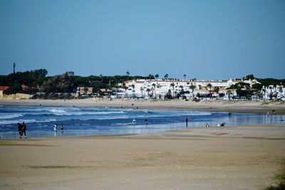 Scenic view of beach against clear blue sky