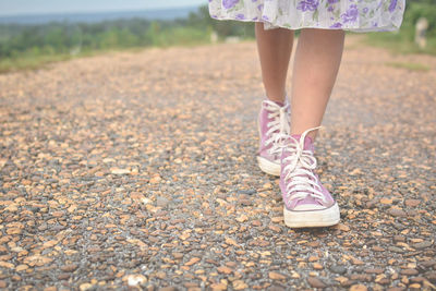 Low section of girl wearing sport shoes