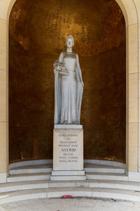 Statue of buddha against wall