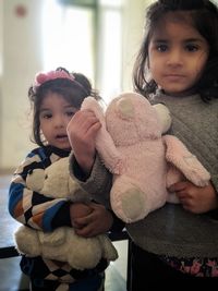 Portrait of cute girl with toy toys