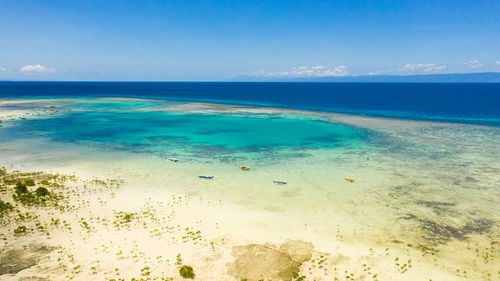 Aerial view of lagoon with turquoise water and boats. coral reef and atoll with turquoise water 