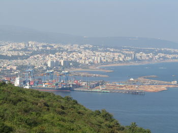 High angle view of buildings and sea against sky