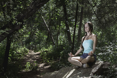 Woman sitting in a forest