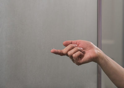 Close-up of hand on wall