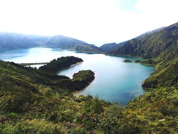 Scenic view of lake and mountains against sky