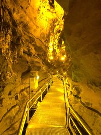 Illuminated tunnel at night