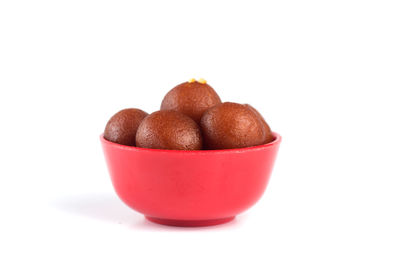 Close-up of fruit in bowl against white background