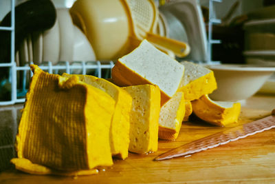 Side angle view of chunk tofu on kitchen table