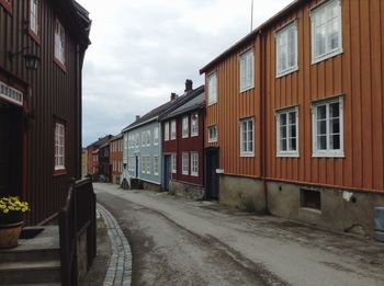 Street amidst buildings against sky