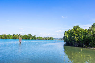 Scenic view of swimming pool by lake against sky