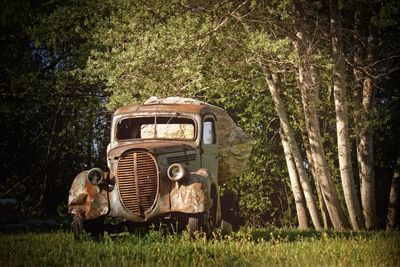 Abandoned truck on grassy field