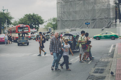 Group of people on road in city