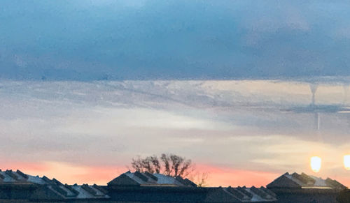 Scenic view of snowcapped mountains against sky during sunset