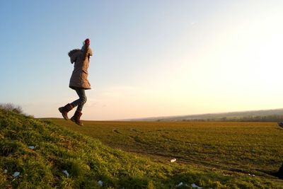 Full length of woman on field against clear sky