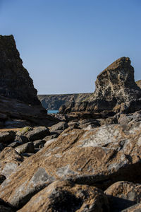 Rock formation on land against clear blue sky