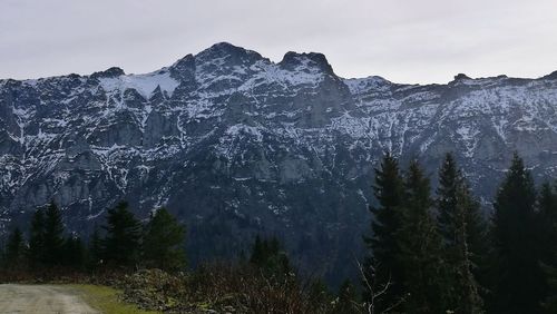 Low angle view of snow covered mountain against sky