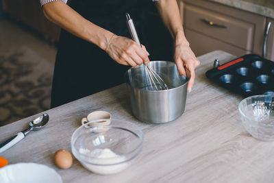 Close-up of cropped hands mixing ingredients