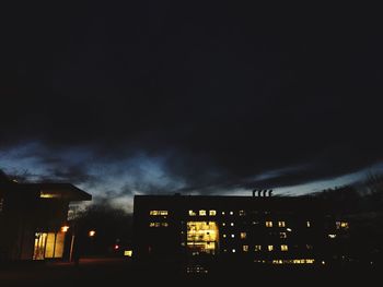 Low angle view of illuminated building against sky at night