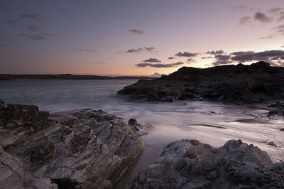 Scenic view of sea against romantic sky at sunset