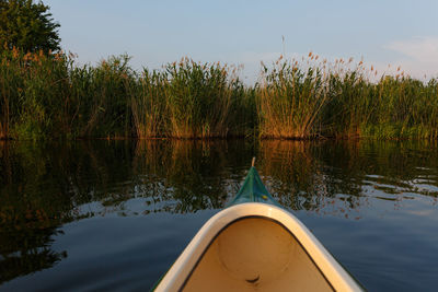 Inside a kayak with lake against sky