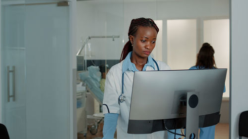 Female doctor using computer in hospital