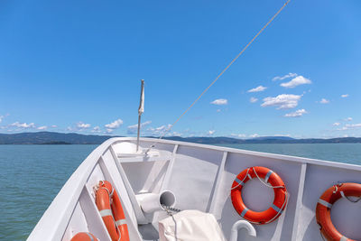 Boat moored in the lake, on a sunny summer day. in the background, the coasts of the island 