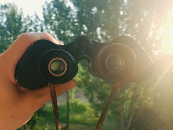 Cropped hand holding binoculars