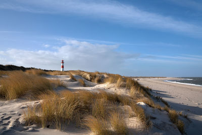 Panoramic image of list east lighthouse against blue sky, sylt, north frisia, germany