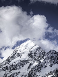 Low angle view of snowcapped mountain against sky