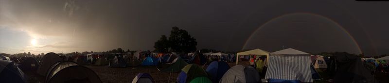 Panoramic view of crowd at music concert against sky