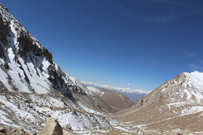 Scenic view of snow covered mountains against sky