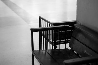 Empty chairs and table against wall