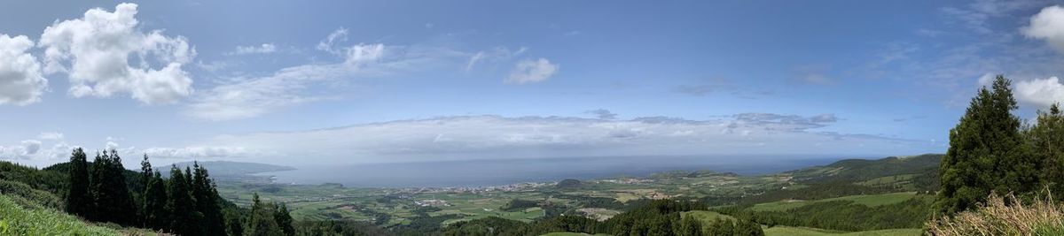 Panoramic view of trees and mountains against sky