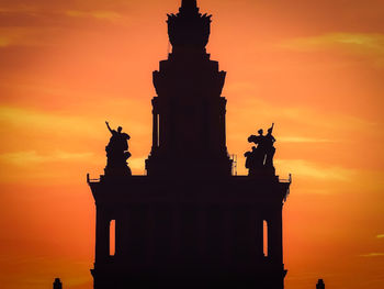 Low angle view of silhouette statue against sky during sunset