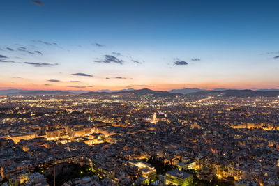 Aerial view of cityscape against sky during sunset