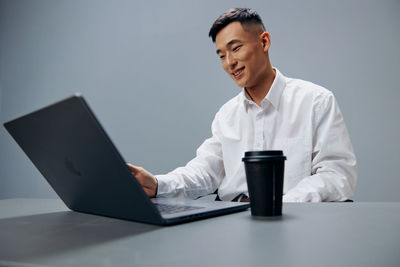 Young woman using laptop at table