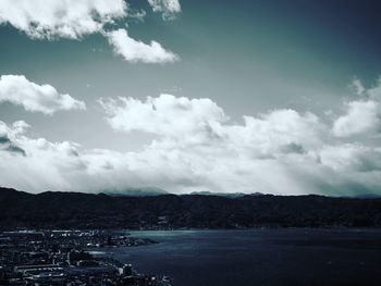 Scenic view of sea and mountains against sky