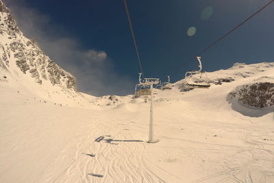 Low angle view of ski lift against sky