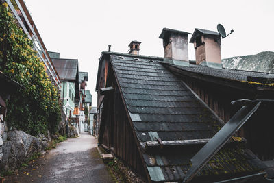 Low angle view of staircase amidst buildings against sky