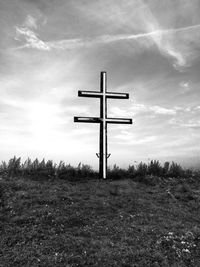 Wind turbines on field against sky