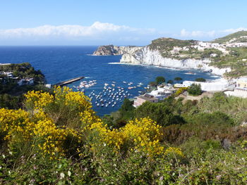 High angle view of sea and mountains against sky