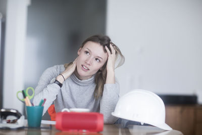 Young woman with long hair learning at home