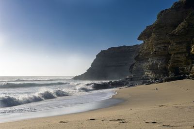 Scenic view of beach against clear sky