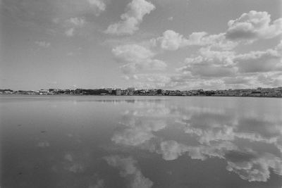 Scenic view of lake against cloudy sky